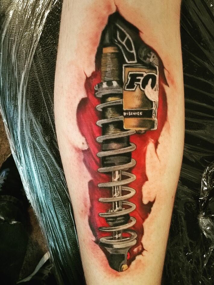 realistic color shock absorber tattoo